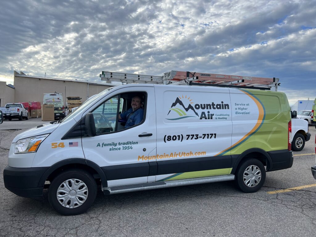 Mountain Air HVAC van with technician smiling from driver's window